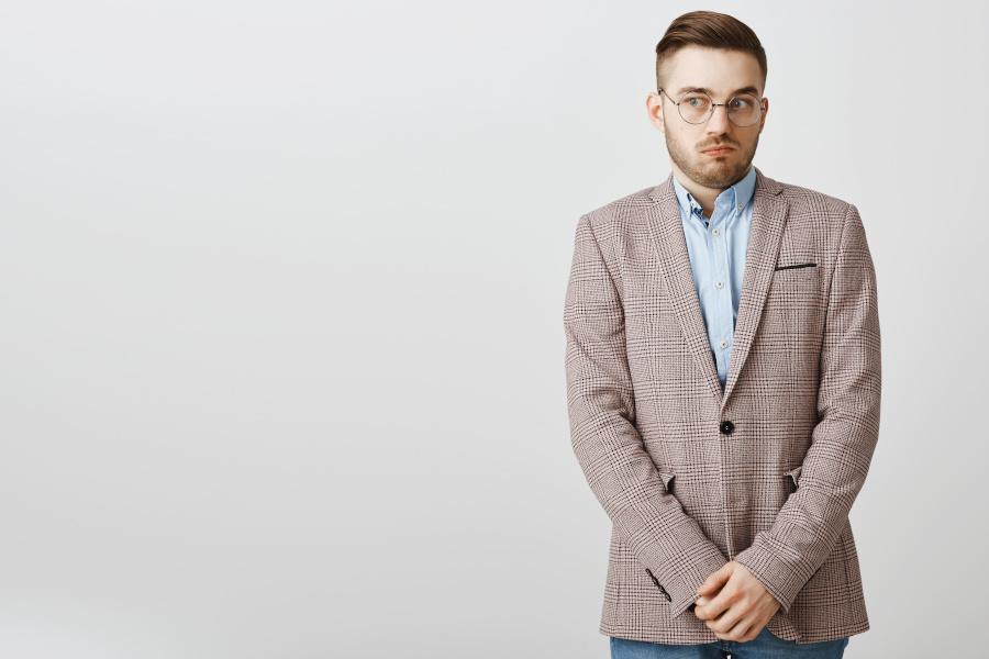 Man standing with his hands folded.