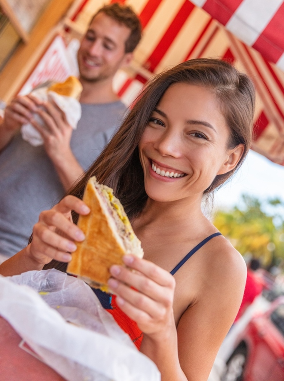 Woman smiling while eating.