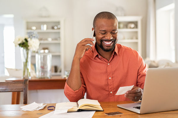 Customer Engagement image of smiling man talking on the phone.