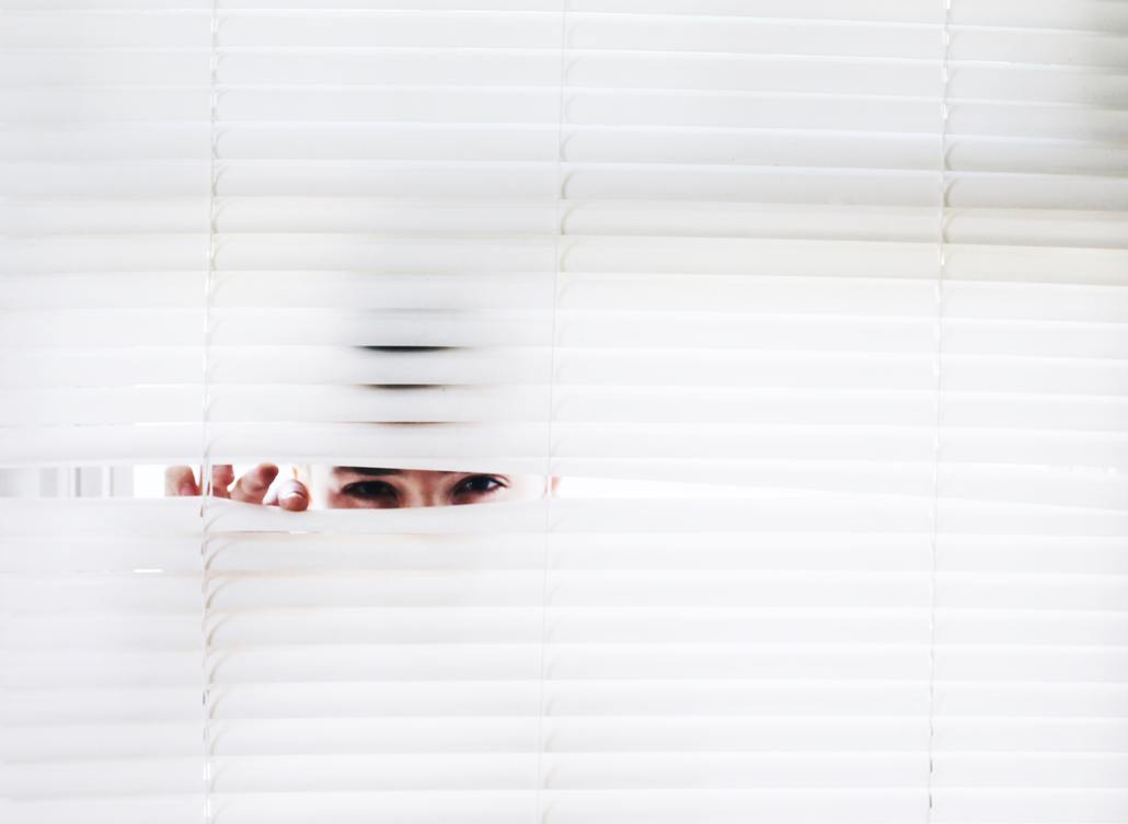 Peeking through blinds.
