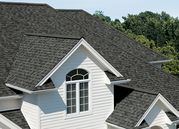 White home with dark grey roof shingles.