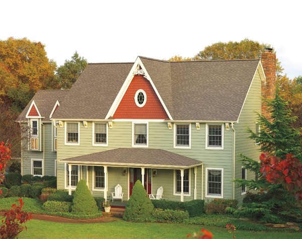 Green home and light grey shingled roof.