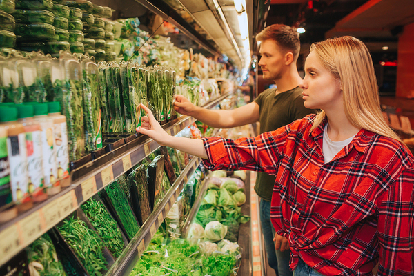 Woman grocery shopping in the produce isle.