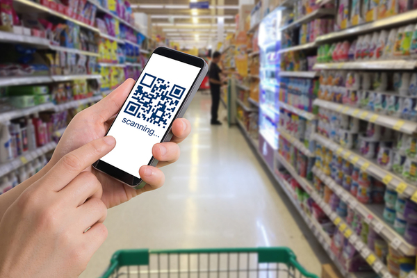 Person in a grocery isle using their smartphone.