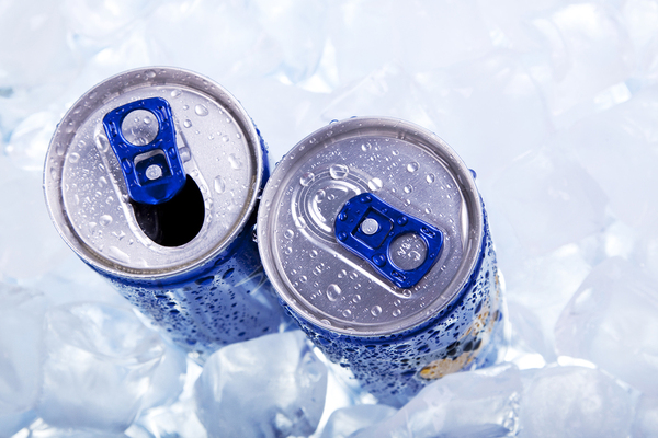 Energy drink cans in an ice bucket.