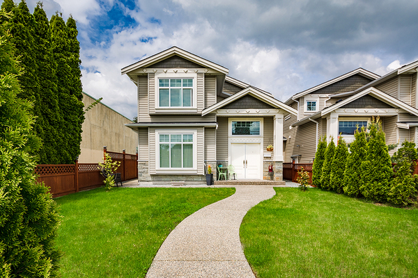 Grey colored home with white trim and gutters.