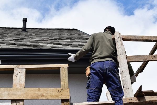 Replacing gutters on a home.