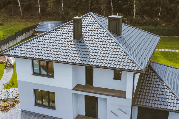 Brown metal roof on a white colored home.