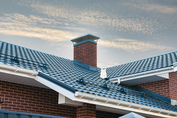 Metal roof on a building with white gutters.