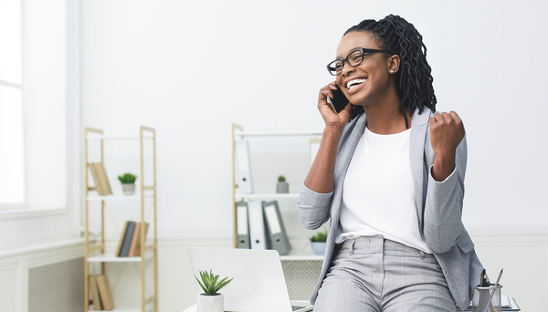 Woman speaking on the phone smiling.