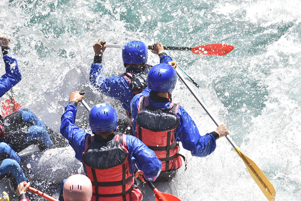 Group of people rafting down a river.
