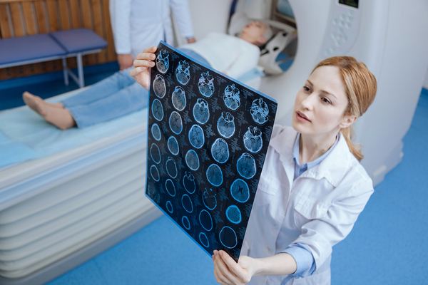 Radiologist tech looking at x-ray images.