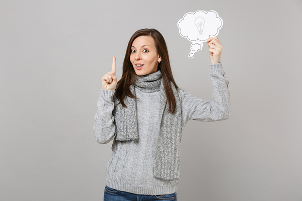 Woman holding a paper cloud in her hand.