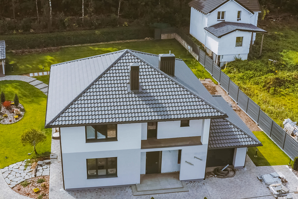 Metal roof on a white home with brown trim.