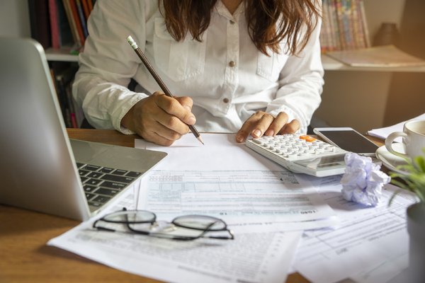 Woman writing on a document.