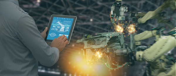 Man controlling machinery with a tablet.
