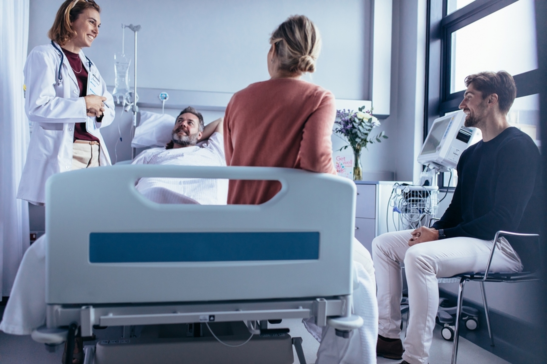 Medical doctor discussing care with a patient and his family.