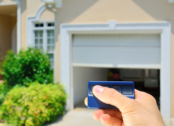 Person using a remote garage door opener.