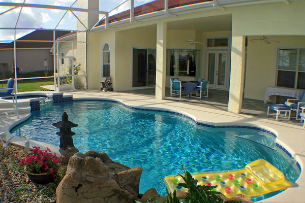 Pool covered with a screened covering.