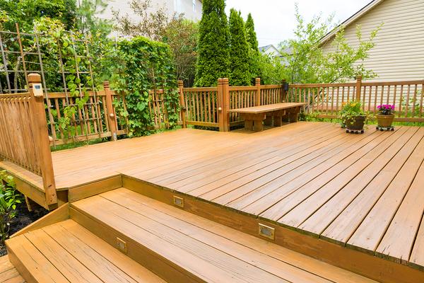 Outside deck with green bushes.