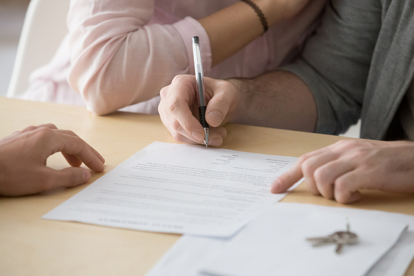 Couple signing a document.