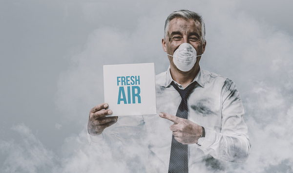 Man with a nose and mouth mask holding a sign Fresh Air.