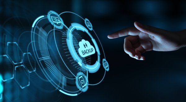 Hand reaching towards a button labeled backup. disaster recovery practices