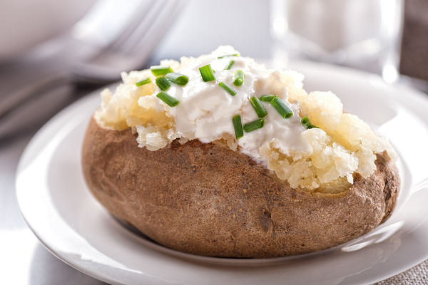 Baked potato with sour cream and chives.