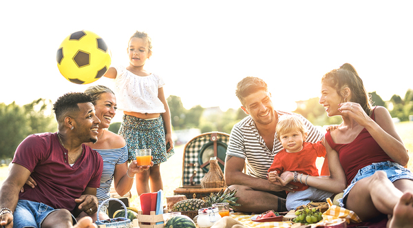 Group of people having a picnic outside.