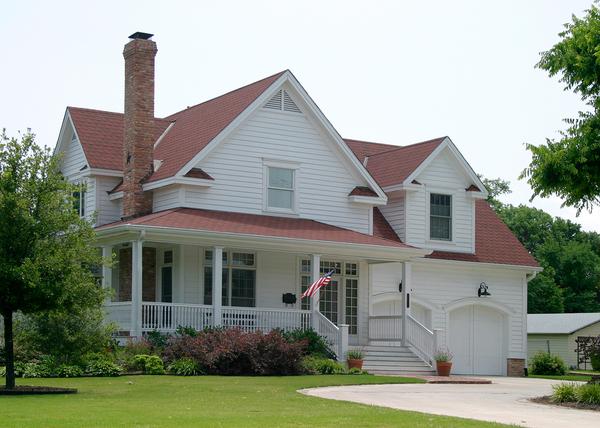 White House with farmer's porch and two car garage.
