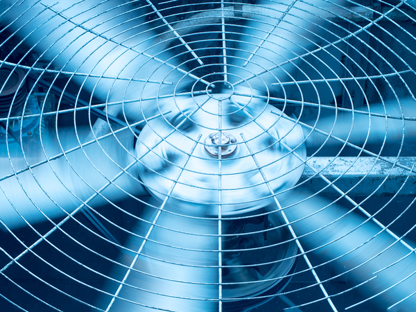 Close up of a metal fan in motion.