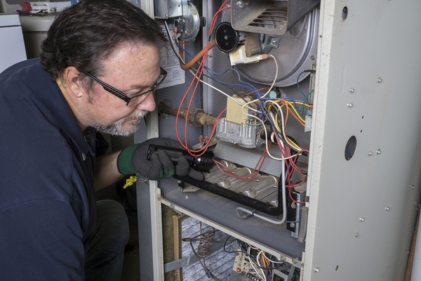 Man repairing a heater unit.