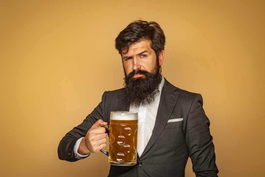 Man holding a large mug of beer.
