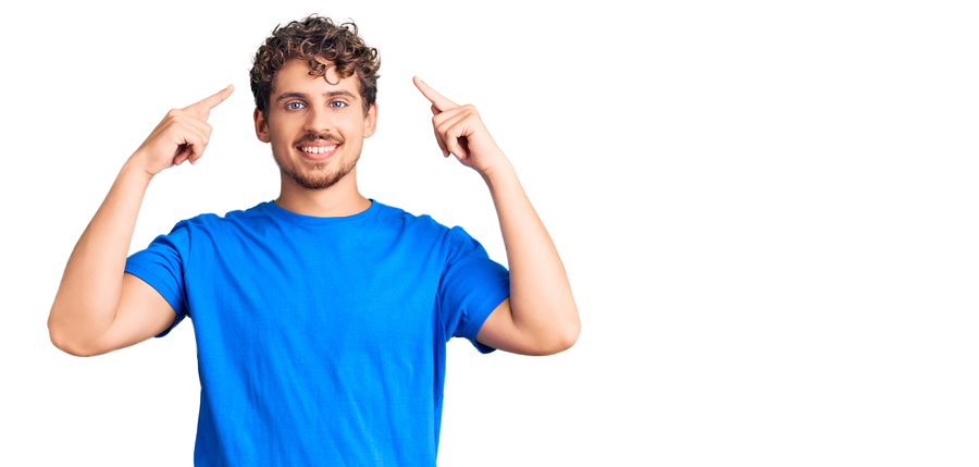 Man pointing to his hair.