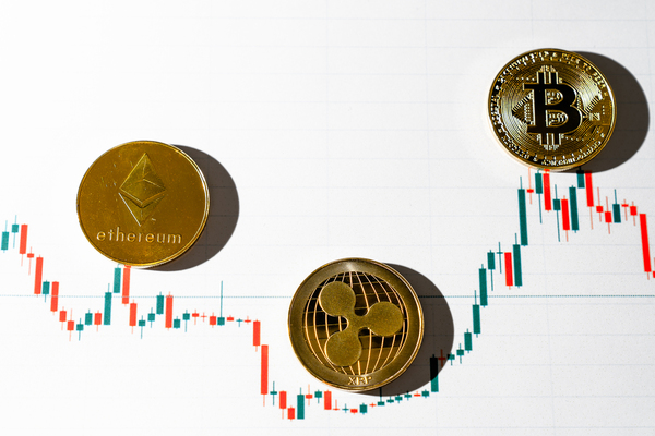 Gold coins with ethereum, ripple and bitcoin symbols.