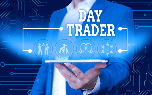 Man in a business suit holding a tablet displaying Day Trader.