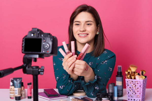 Woman making a makeup training video.