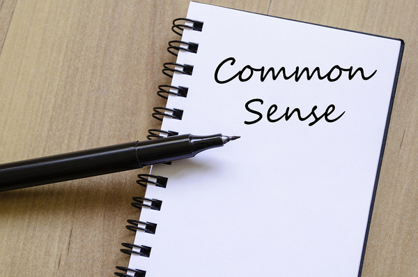 The words common sense written in a notebook.