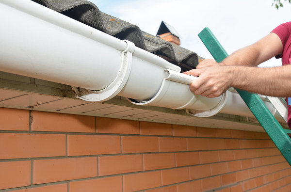 Person installing gutters.