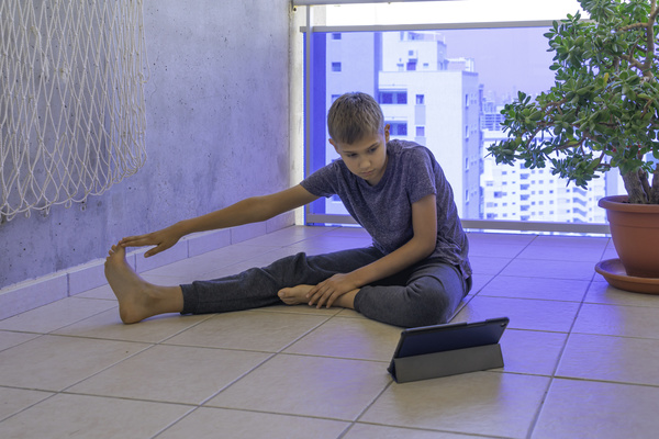 Teen stretching on the floor.