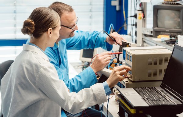 Two colleagues working on computer hardware together.