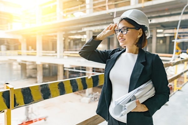 Woman wearing a hard hat at a construction site.