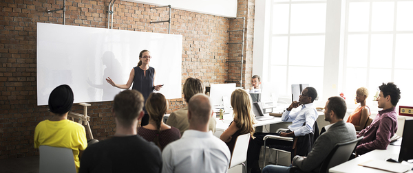 Classroom filled with students and an instructor presenting.