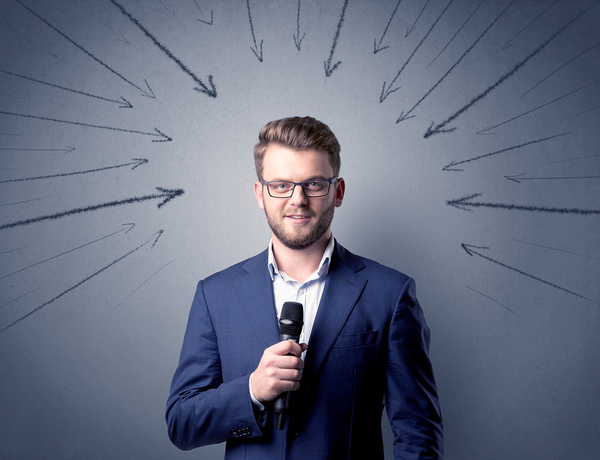 Man speaking with a microphone.