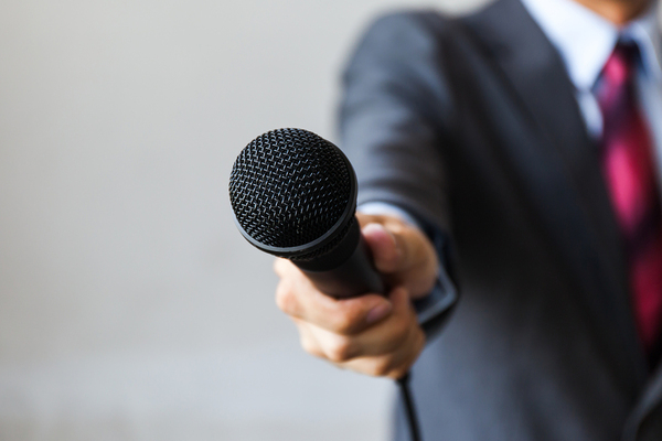 Man holding a microphone.