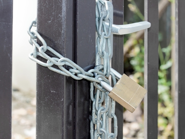 Chain and lock around a metal gate.