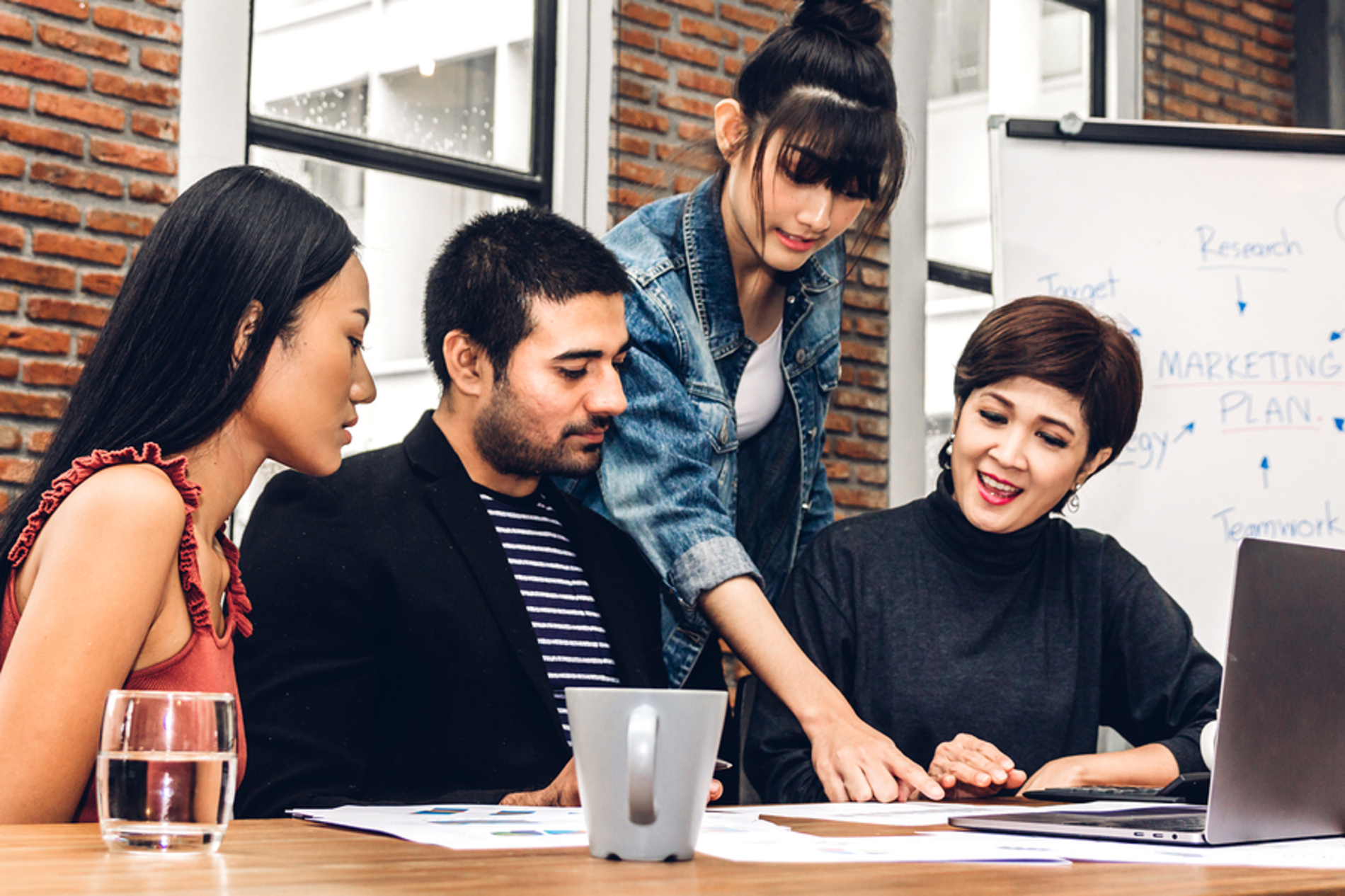 Group of colleagues discussing a project at a table.