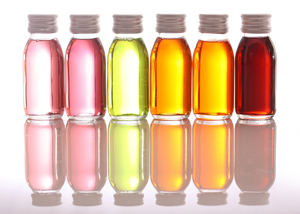 Glass containers containing brightly colored liquids.