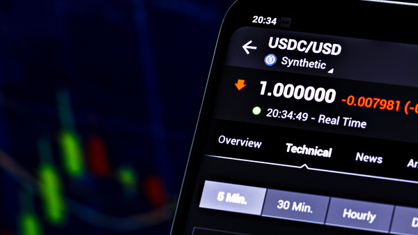 USDC/USD displayed on a phone.