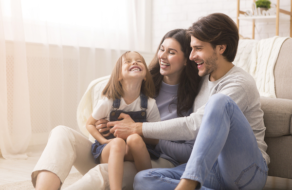 Smiling family of three.
